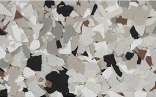A close-up of scattered, irregularly shaped flakes in shades of white, gray, black, and beige.