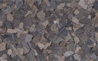 Close-up of small, jagged, gray and beige stones or gravel filling the entire frame.