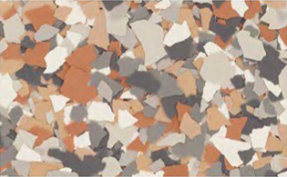 A close-up of a surface with scattered chips in shades of brown, gray, white, and beige.